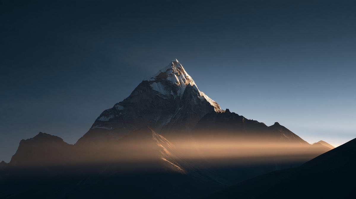 A Himalayan peak rising above the mist in warm morning light