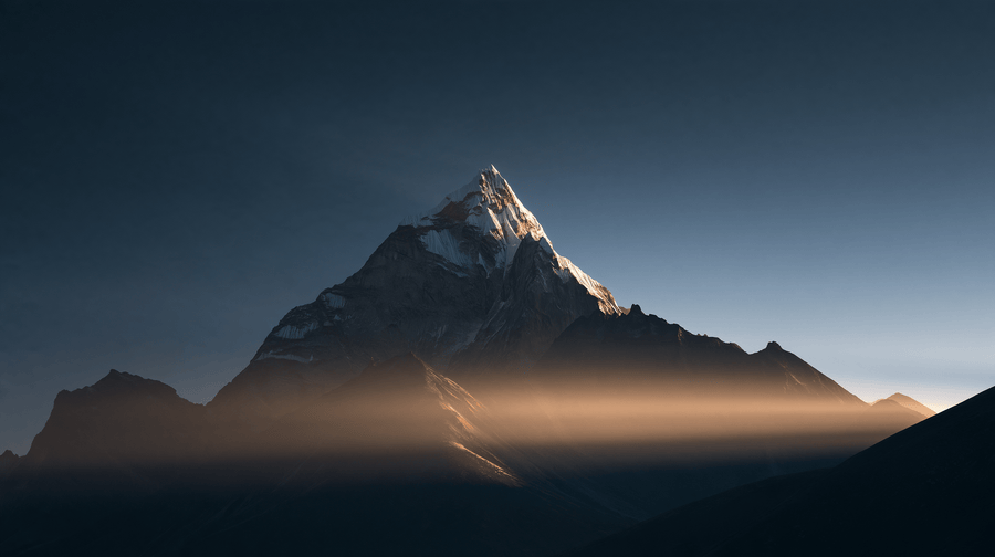 A Himalayan peak rising above the mist in warm morning light