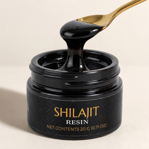 Montavita Shilajit Resin dripping from a gold spoon into the open jar